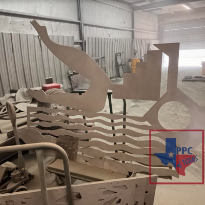 A vibrant and intricate metal sculpture titled 'Katie Trail Art Piece,' showcasing a blend of colors and textures. This artwork, created by a New York artist and brought to life by Powder & Protective Coating Texas, stands as a testament to artistic collaboration and expert craftsmanship.
